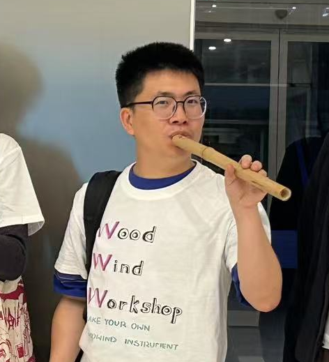 Kenny Ma playing a handmade woodwind instrument